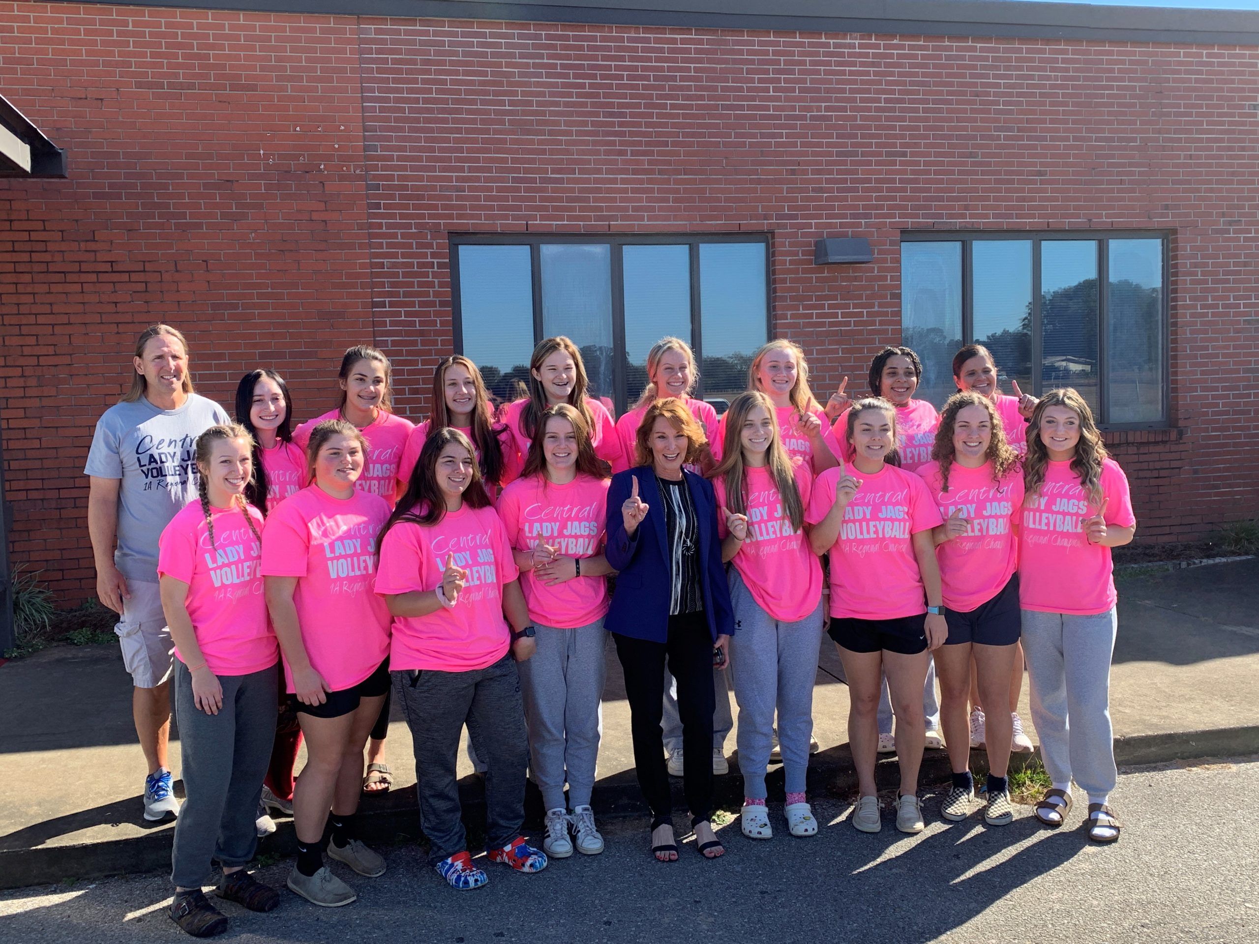 Central High School's volleyball team poses with Superintendent Karen Barber before heading off to compete in Saturday's Final Four. They are ranked third in 1A.