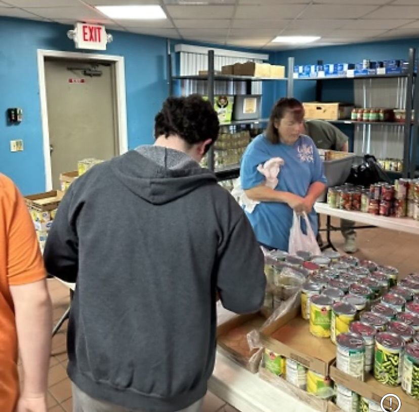 Share Your Heart volunteers bag groceries to help those with immediate needs.