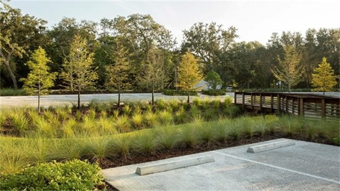 Example of a bioswale and permeable pavement parking lot surface. The bioswales help remove pollutants from surface runoff water.