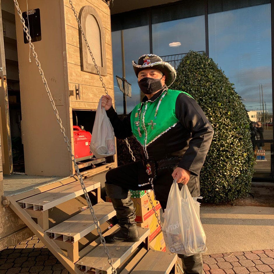 A Krewe of Lafitte member gets ready to place groceries inside the ship for the 2020 Fill the Pirate Ship food drive, which was used to collect donations to the Manna Food Bank. This year's event also collects food and cash donations to feed the hungry in Escambia and Santa Rosa Counties.
