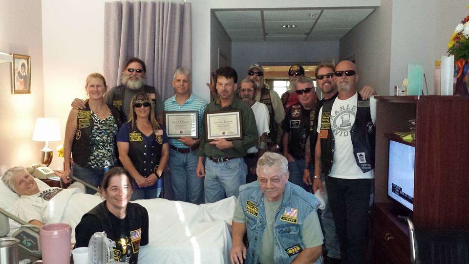 Members of the Combat Veterans Motorcycle Association recognized the actions of two friends, Michael Moore and Rodney Busbee (pictured with plaques left to right) who stopped to help a CVMA member, Duke Boutwell, and his wife, Brenda, after a serious traffic accident April 2 on Munson Highway.
