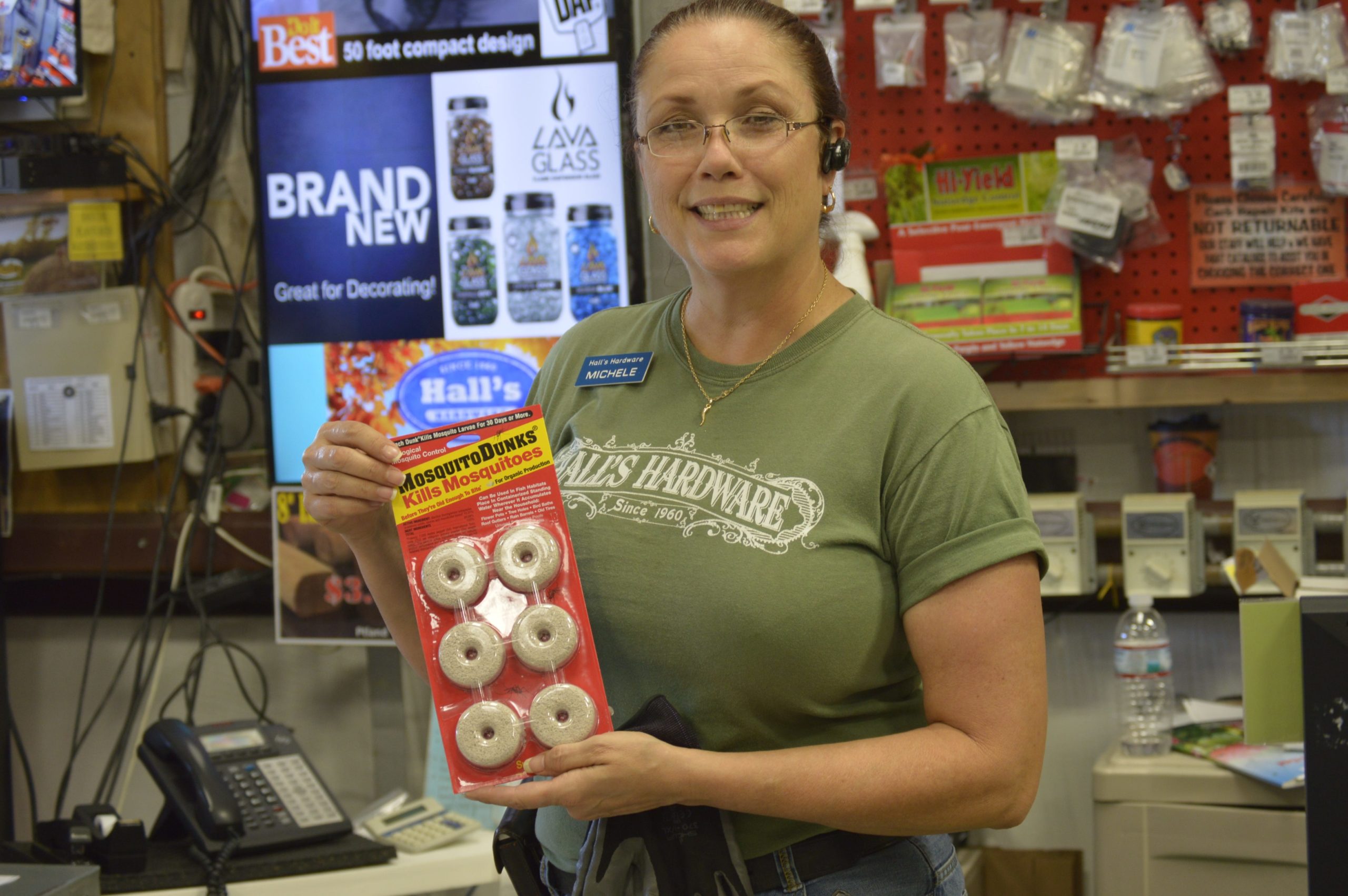 Michele Hunsucker, an employee at Hall's Hardware and Lumber in Milton, displays a product used to eliminate mosquitoes. Placing MosquitoDunks, or tablets, in standing water can kill mosquito larvae. (Matt Brown | Press Gazette)
