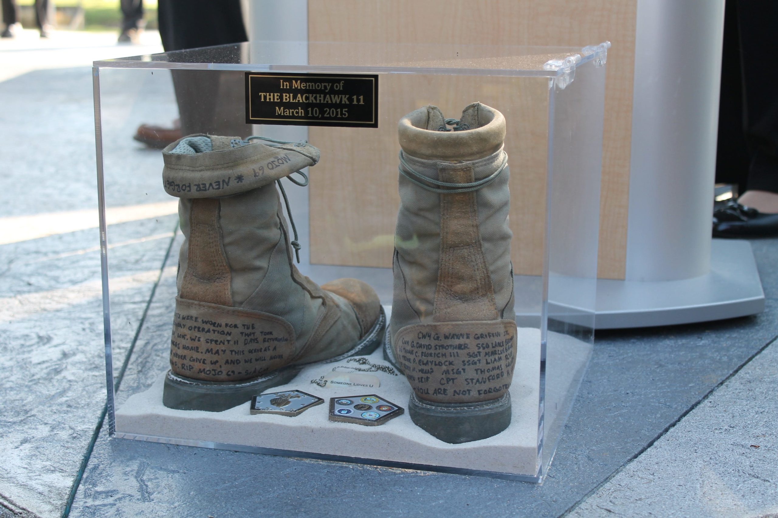 An anonymous donor left these combat boots at the Navarre Black Hawk Memorial during last year's anniversary. They bear the names of 11 victims of the accident and will be on permanent display in the Navarre Park visitor's center. AARON LITTLE | Press Gazette