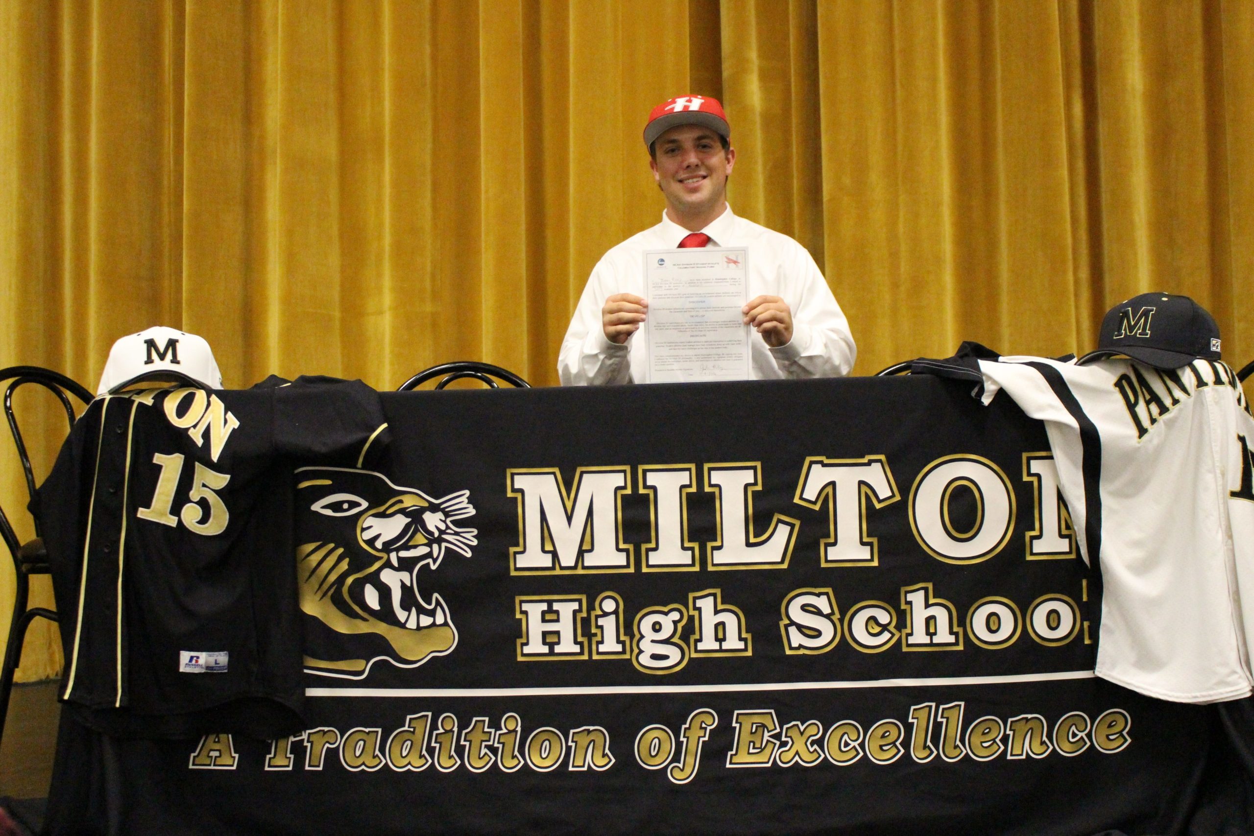 Justin Raley of Milton High School celebrates signing a baseball scholarship with Huntingdon College in Montgomery, Ala., on Nov. 16. (Special to the Press Gazette)