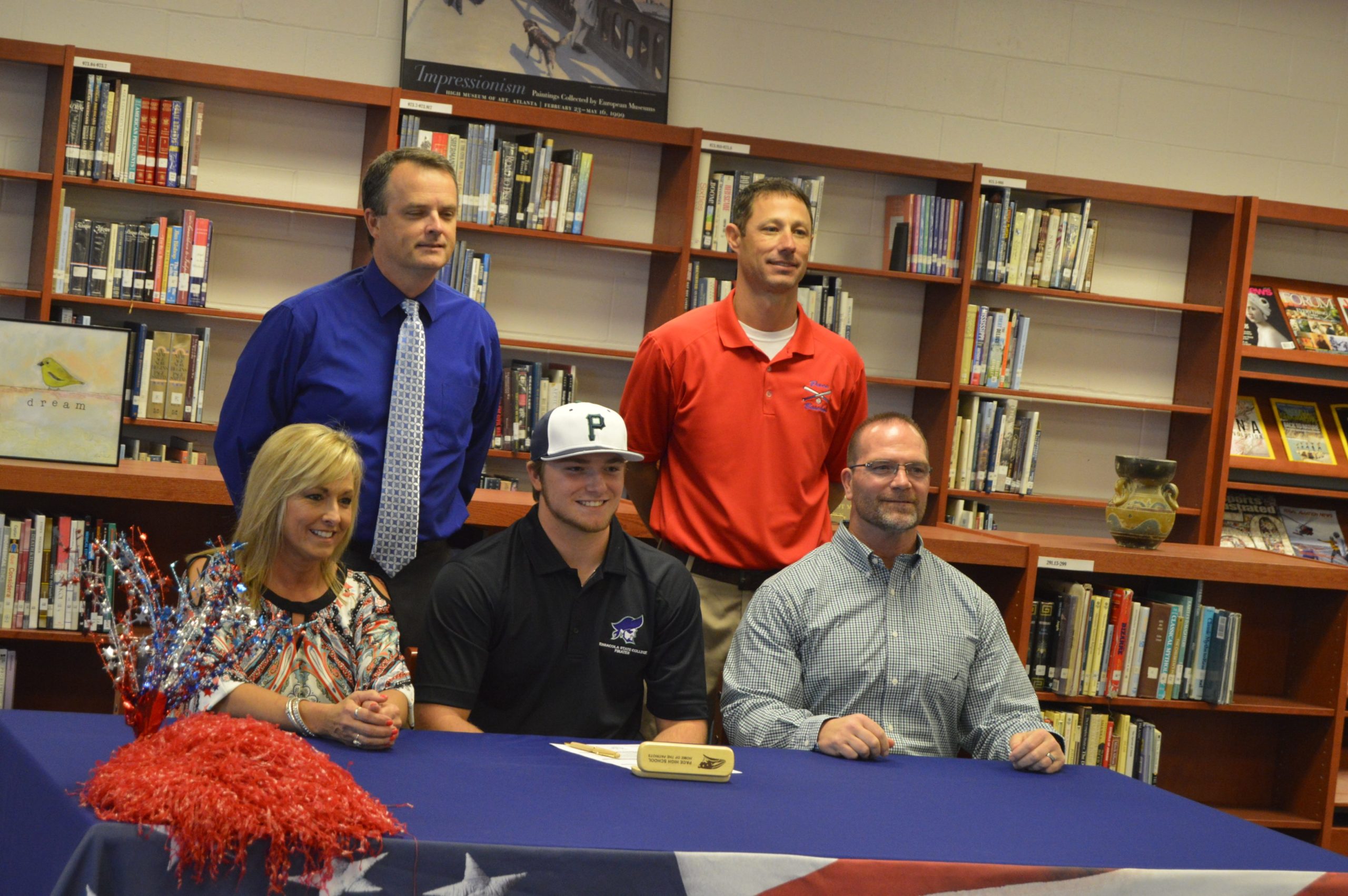 Jake Nemith, center, of Pace High School celebrates signing a baseball scholarship with Pensacola State College on Wednesday. Nemith is joined by his parents, Gina Nemith-Berklow, left, and Chris Nemith, right. Standing behind the family are PHS Principal Stephen Shell and PHS baseball coach Jason McBride. (MATT BROWN | Press Gazette)
