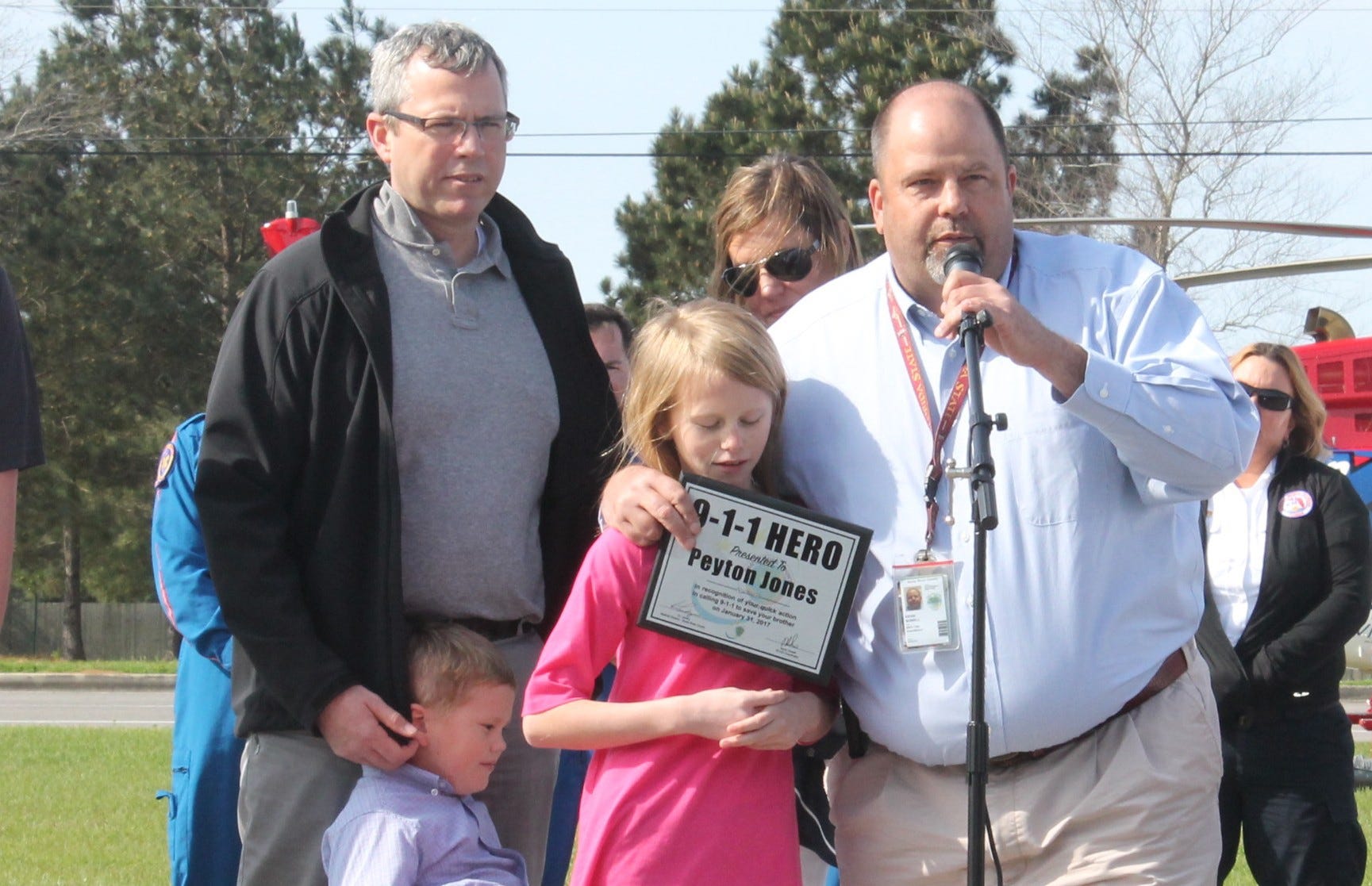 Pictured from left are Peyton Jones' father, Kevin Jones; her brother, Holton Jones; her mother, Genia Jones; Peyton; and Santa Rosa County Emergency Management's 9-1-1 coordinator, Kevin Sowell. Sowell presented the 9-1-1 Hero award to Peyton, who called 9-1-1 to save her brother Holton's life. [AARON LITTLE | Press Gazette]