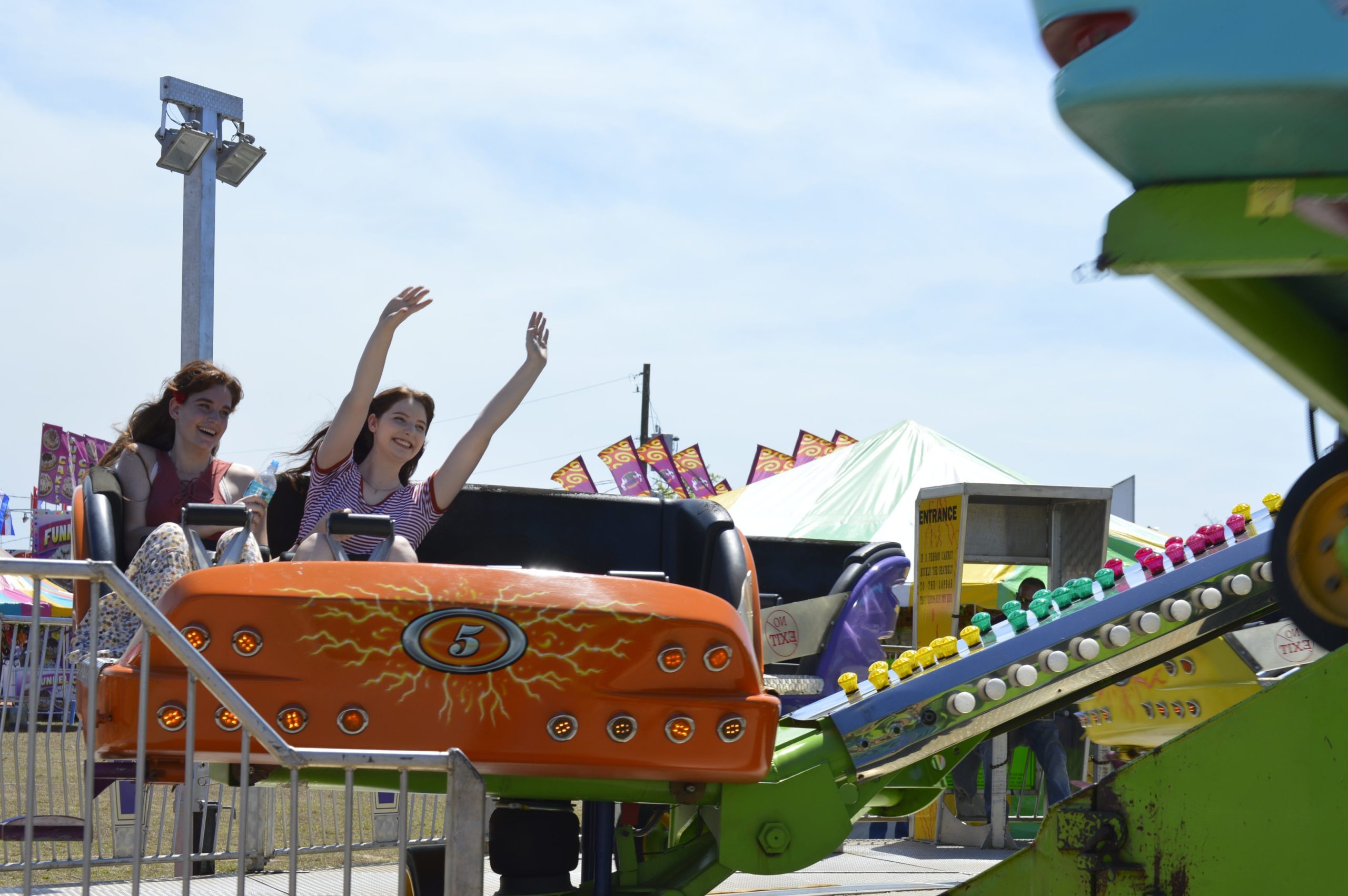 Zena Carpenter, a local artist, enjoys an amusement ride with her friend during the Santa Rosa County Fair. [ALICIA ADAMS | Press Gazette]