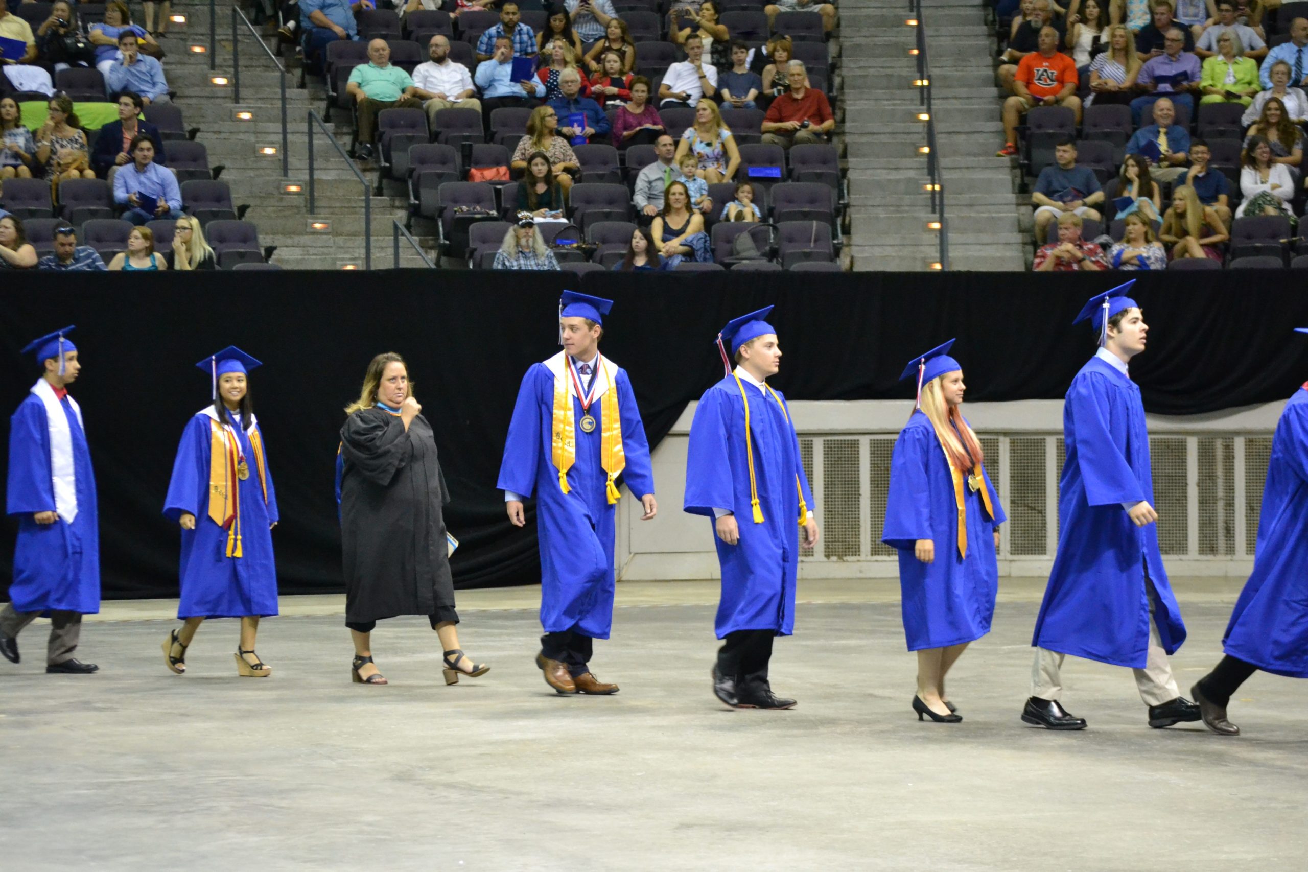 Pace High School graduates proceed to their seats and wait for the ceremony to commence. [ALICIA ADAMS | Press Gazette]