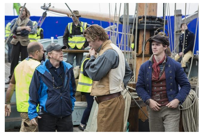 Ron Howard discusses a scene with Chris Hemsworth during the shooting of "In the Heart of the Sea."