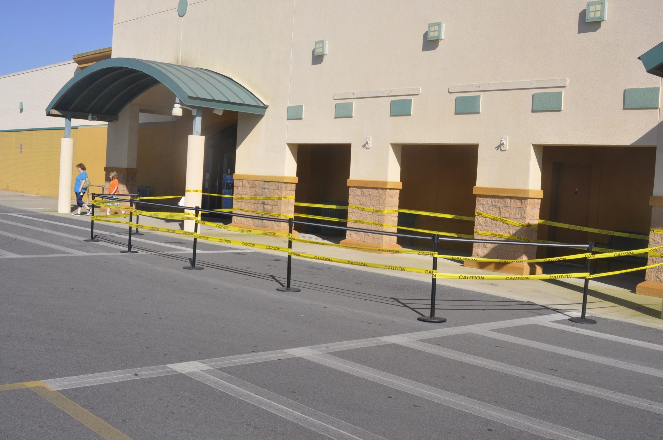A portion of the Beall’s Department Store in Milton has a caution tape barrier set up near the entrance to keep residents safe.