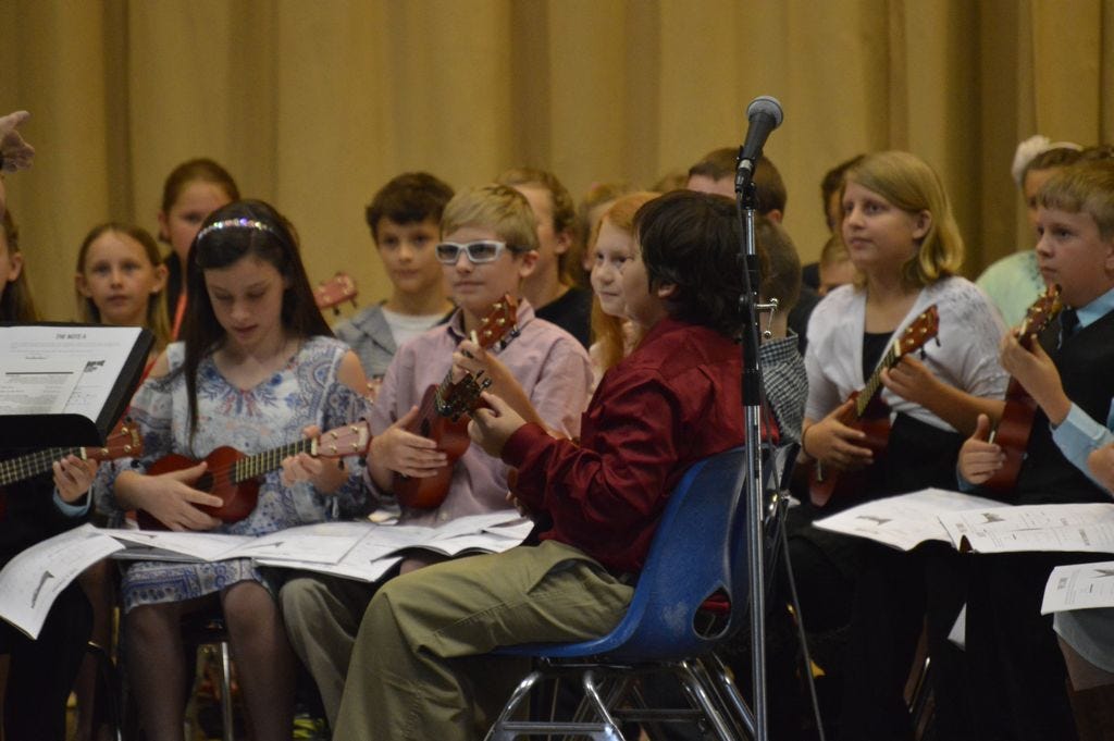 Jay Elementary School fourth-graders look for direction from music teacher Kristi White during an April 19 ukulele concert.