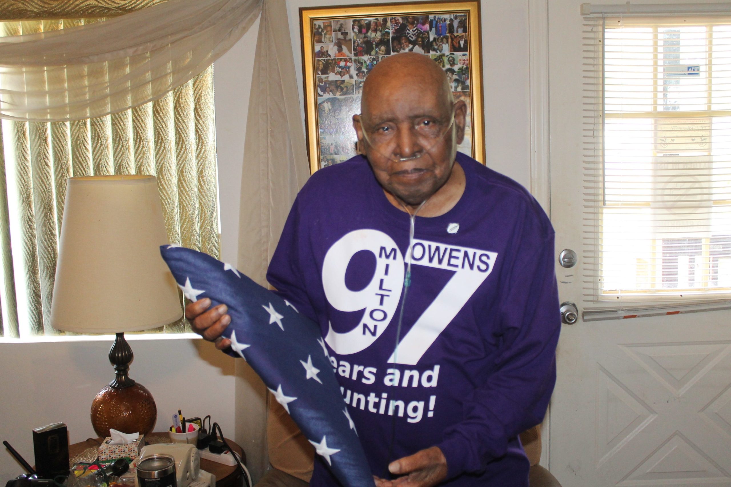 Milton Owens holds his United States Flag given to all veteran's of the military. Owens served during World War II. [KEVIN BOYER | Press Gazette]