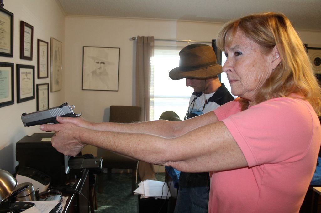 Kay, in a concealed carry permit class, works on “dry firing,” where the class learned how to handle a gun without ammo. As Second Amendment interpretation changes, what she can and cannot do with this gun does so as well from how she carries it to self defense.