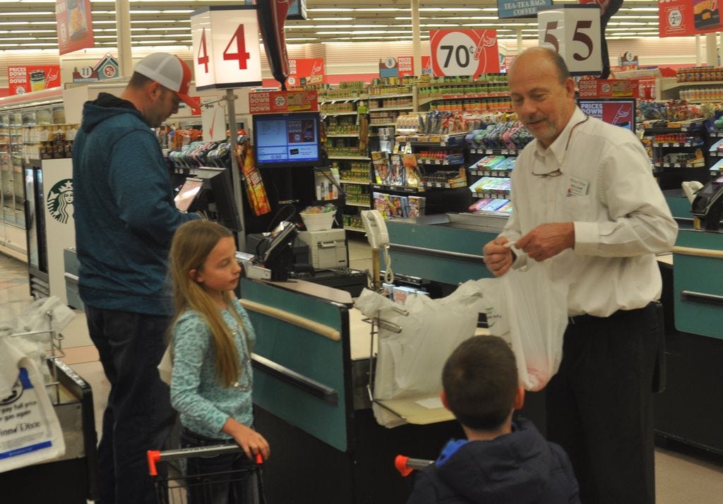 In his last week as the store manager of the Winn-Dixie Grocery Store in Pace, William Beech is seen bagging groceries for customers at the checkout registers. Coincidentally, bagging groceries is just how Beech started his 45-year career with the same company.