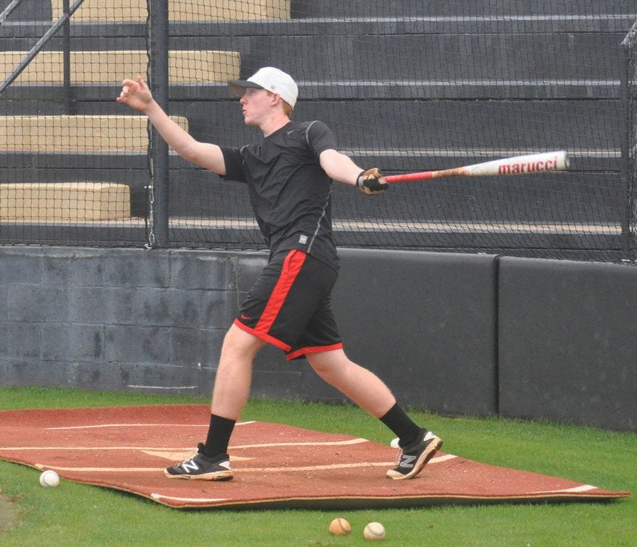 Dalton Jernigan, who also plays at second base for Milton High School's baseball team, takes a swing during practice at the MHS baseball field.