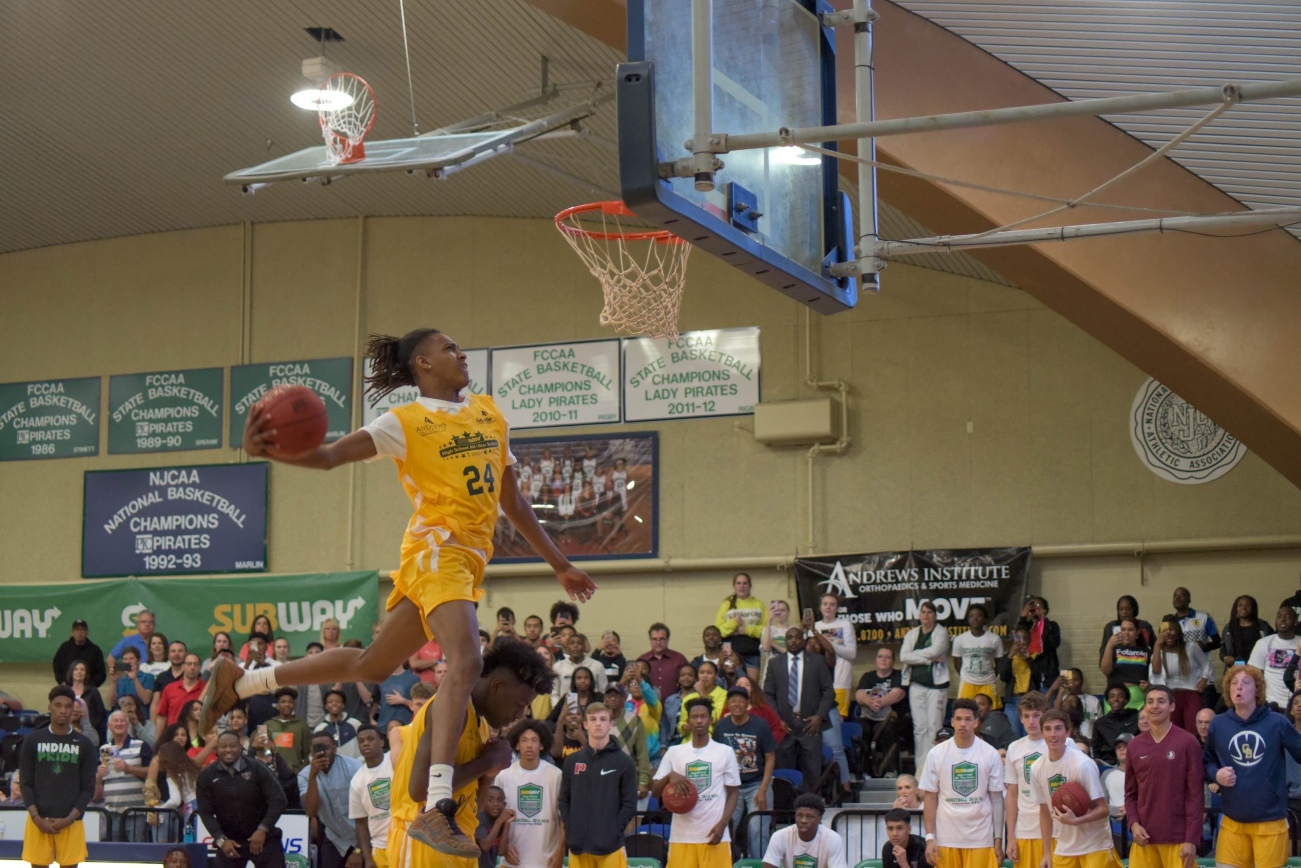 The crowd marvels as Adrian Walker dunks over Choctaw's Josh Williams. [PHOTO BY JOHN ASKEW]