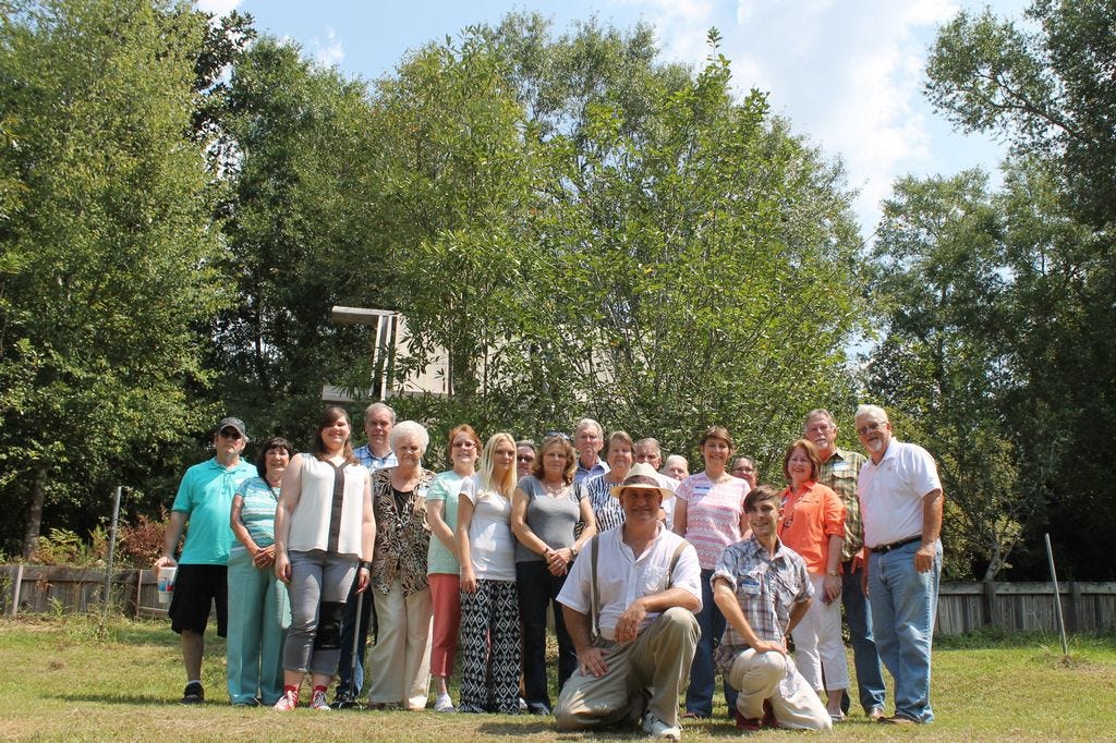 These 19 direct and indirect descendents of Civil War vetern and Shell apple cultivator, Greenberry Henry Shell gathered at Clear Creek Farm, owned by Ray Davis (far right) September 5. Kneeling is Blake Arant, great great grandson of Shell, and Arant’s son, Aiden Arant. Between them is Sherry Grachis, great great niece to Shell who organized this reunion through Facebook. Billy Reeves, fourth from the left, his own family research led him to Shell and to Davis through the Santa Rosa County Extension office. They’re all standing before the largest Shell Apple tree on Davis’ farm.
