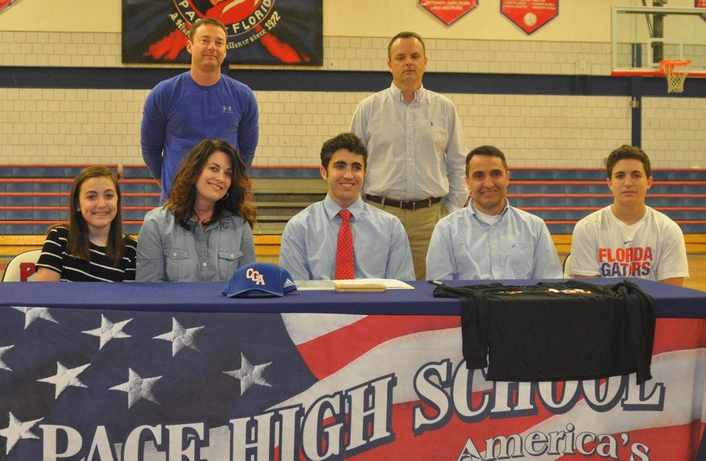 Surrounded by his family, Nathan Harshany, center, celebrates signing a basketball scholarship with the United States Coast Guard Academy. Standing behind Nathan from the left are PHS Head Basketball Coach Carl Pippin and PHS Principal Stephen Shell.