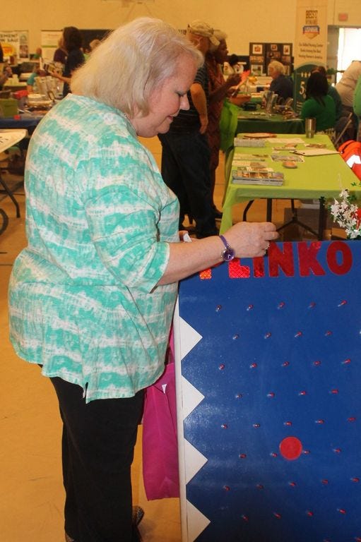Cheryl Hayden Freret, a Milton native and Milton High graduate, played Plinko at the Harris Healthcare Management Company, Inc.