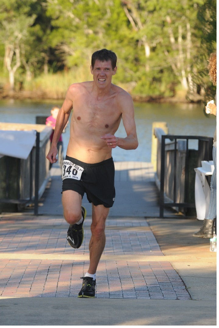 Mitchell Jone is seen coming off the Milton Riverwalk approaching the third mile maker in the Milton Riverwalk Run 5K. Mitchell, from Navarre, took the overall men’s title in a time of 17:02.